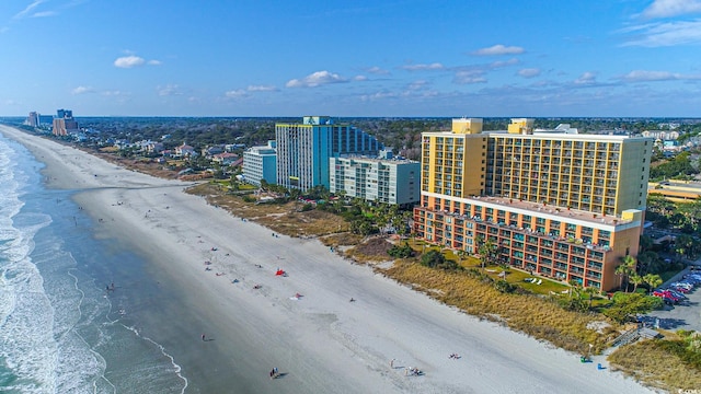 birds eye view of property featuring a beach view and a water view