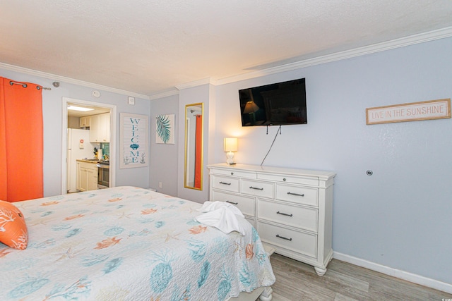 bedroom featuring light hardwood / wood-style flooring, a textured ceiling, connected bathroom, crown molding, and white fridge