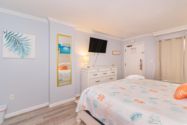 bedroom featuring light hardwood / wood-style flooring and ornamental molding