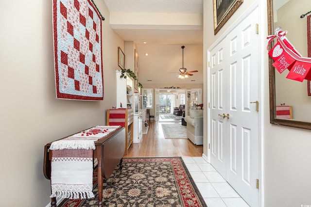 corridor with vaulted ceiling and light hardwood / wood-style flooring