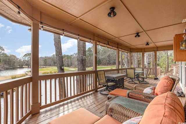 sunroom / solarium with a water view