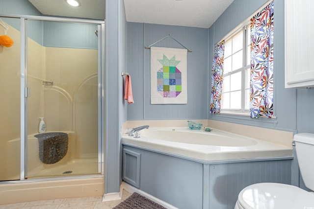 bathroom with tile patterned flooring, a textured ceiling, independent shower and bath, and toilet