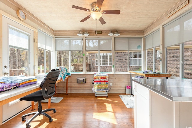 sunroom / solarium with a wealth of natural light and ceiling fan