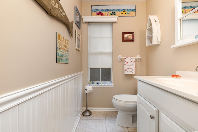 bathroom with vanity, tile patterned flooring, and toilet