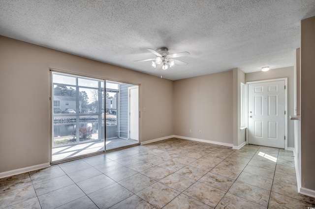 2151 Clearwater Dr Unit C, Surfside Beach, SC 29575 - unfurnished room with a ceiling fan, light tile patterned flooring, baseboards, and a textured ceiling
