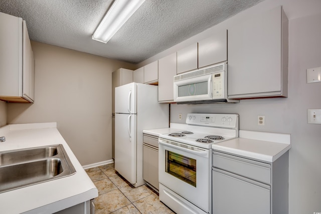 2151 Clearwater Dr Unit C, Surfside Beach, SC 29575 - kitchen with white appliances, a sink, light countertops, a textured ceiling, and light tile patterned flooring