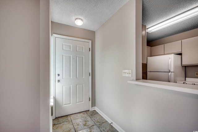 2151 Clearwater Dr Unit C, Surfside Beach, SC 29575 - entryway featuring a textured ceiling, light tile patterned flooring, and baseboards