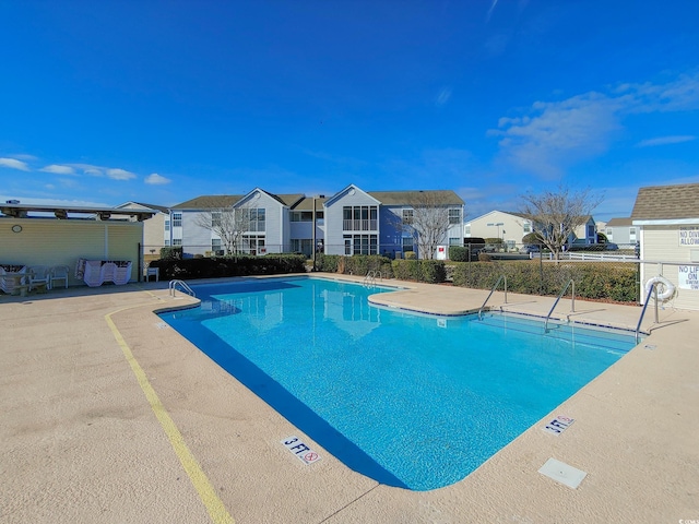 2151 Clearwater Dr Unit C, Surfside Beach, SC 29575 - community pool featuring a residential view, fence, and a patio