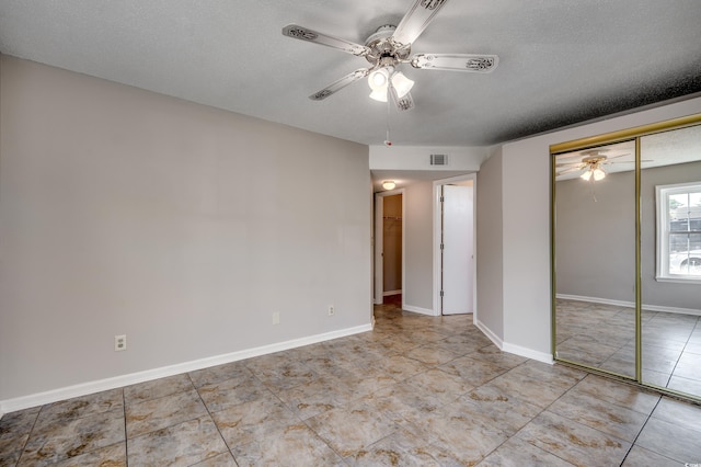 2151 Clearwater Dr Unit C, Surfside Beach, SC 29575 - unfurnished room with ceiling fan, a textured ceiling, tile patterned flooring, and baseboards