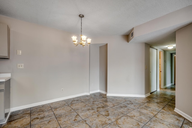 2151 Clearwater Dr Unit C, Surfside Beach, SC 29575 - unfurnished dining area with a chandelier, light tile patterned floors, a textured ceiling, and baseboards