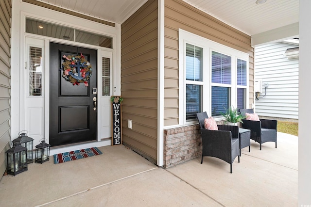 view of exterior entry with a porch