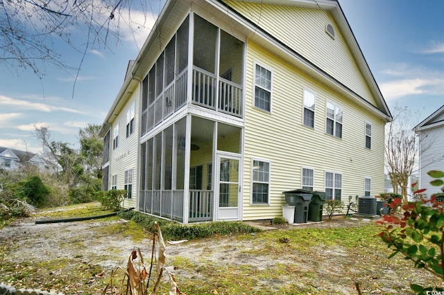 back of house featuring cooling unit and a sunroom