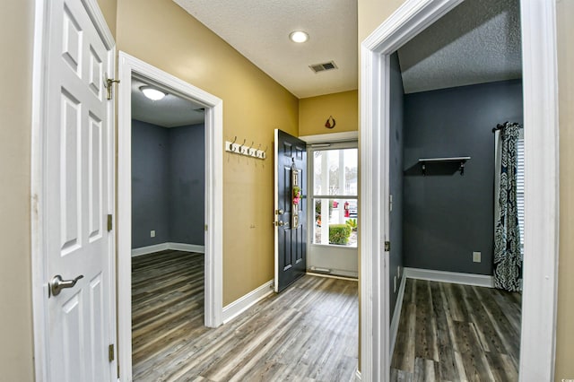 foyer entrance featuring hardwood / wood-style flooring and a textured ceiling