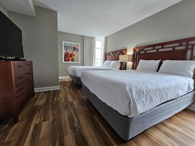 bedroom with dark hardwood / wood-style flooring