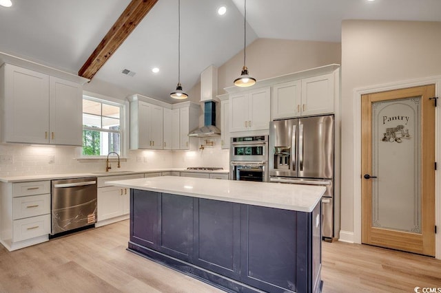 kitchen featuring wall chimney exhaust hood, stainless steel appliances, lofted ceiling with beams, visible vents, and light countertops