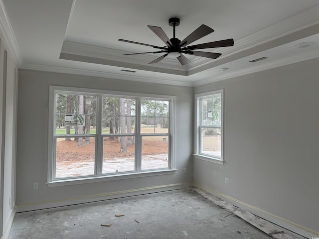 unfurnished room featuring ceiling fan, ornamental molding, and a raised ceiling