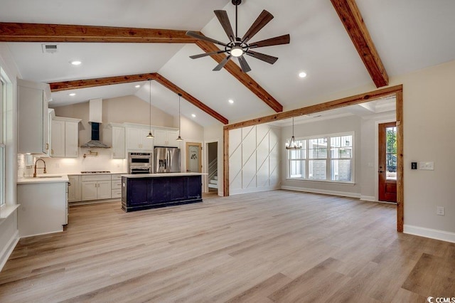 unfurnished living room featuring stairway, light wood-style floors, beamed ceiling, and ceiling fan with notable chandelier