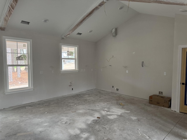 empty room featuring vaulted ceiling