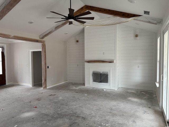 unfurnished living room featuring lofted ceiling, a large fireplace, and wood walls