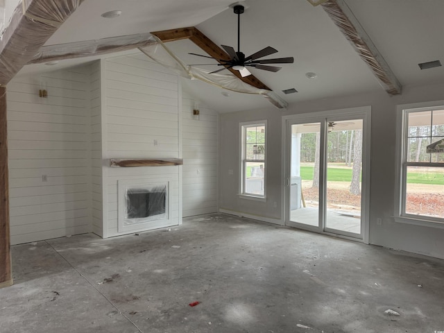 unfurnished living room with lofted ceiling with beams and wooden walls