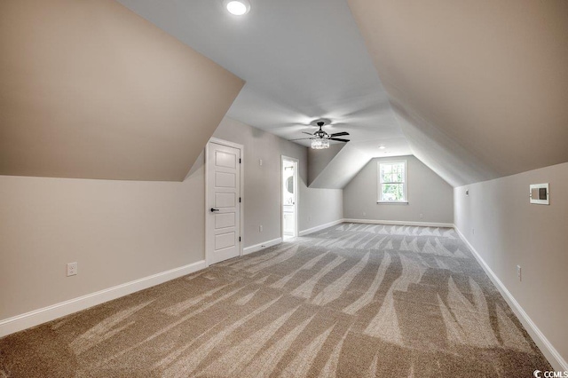 bonus room featuring baseboards, vaulted ceiling, a ceiling fan, and light carpet
