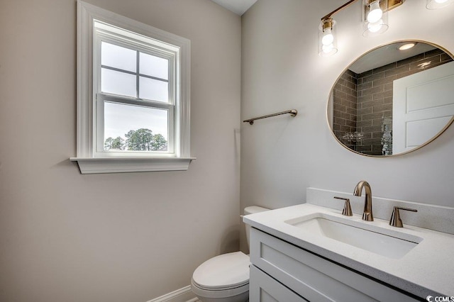 full bathroom with vanity, a tile shower, and toilet