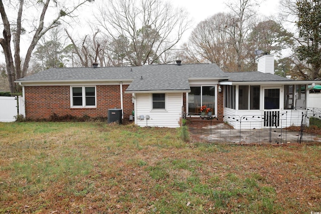 back of house featuring central AC, a yard, a patio area, and a sunroom