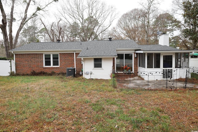 back of property featuring cooling unit, a lawn, a sunroom, and a patio area