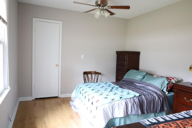 bedroom with light hardwood / wood-style flooring and ceiling fan