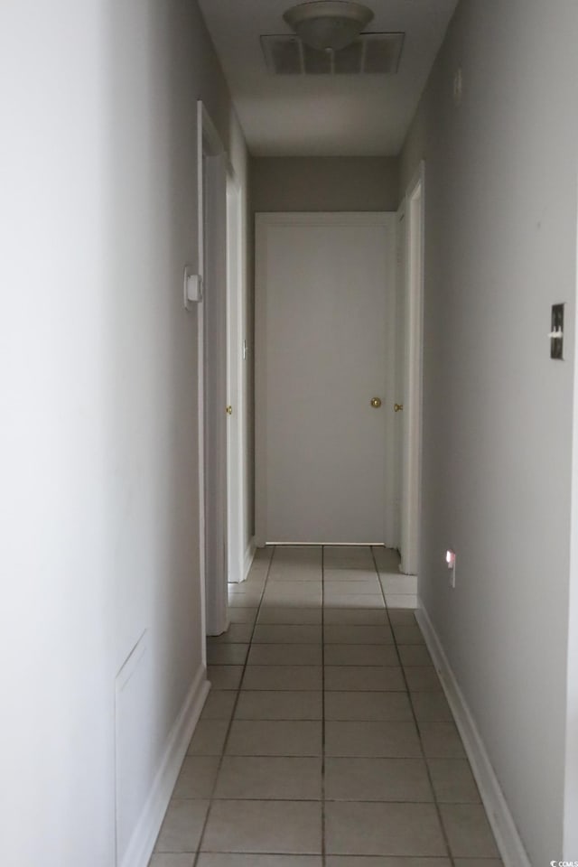 hall featuring light tile patterned floors