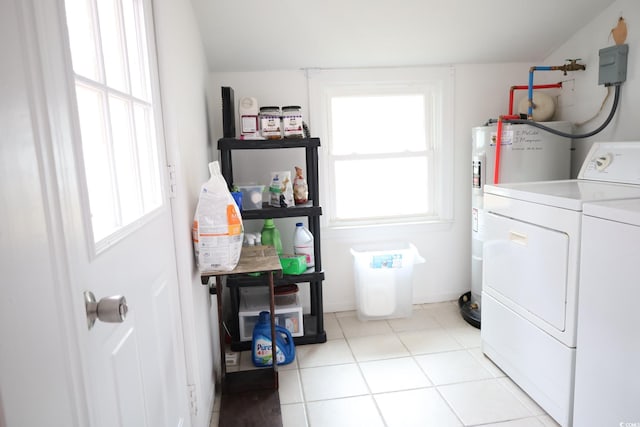 laundry room with water heater, independent washer and dryer, a healthy amount of sunlight, and light tile patterned flooring