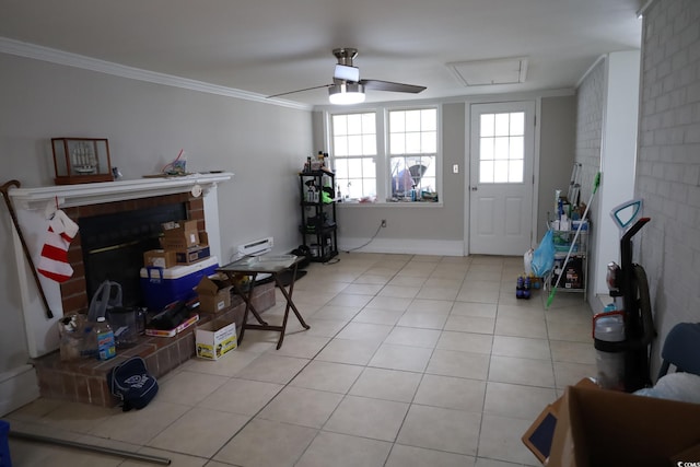 tiled entrance foyer featuring crown molding and ceiling fan