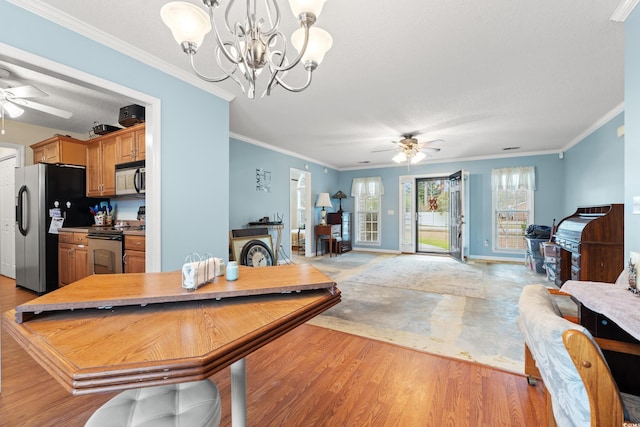 dining room featuring ornamental molding, ceiling fan with notable chandelier, and light wood-type flooring