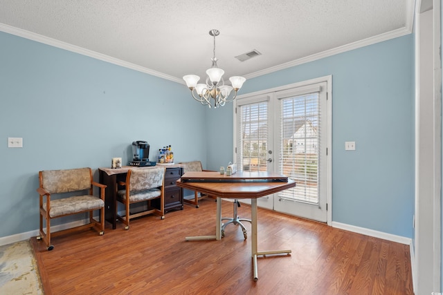 home office with hardwood / wood-style flooring, ornamental molding, and a textured ceiling