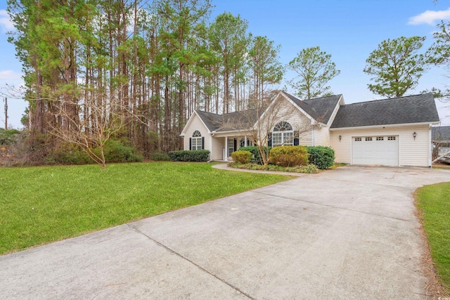 view of front of property with a garage and a front lawn