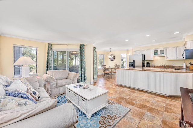 living room featuring crown molding and sink