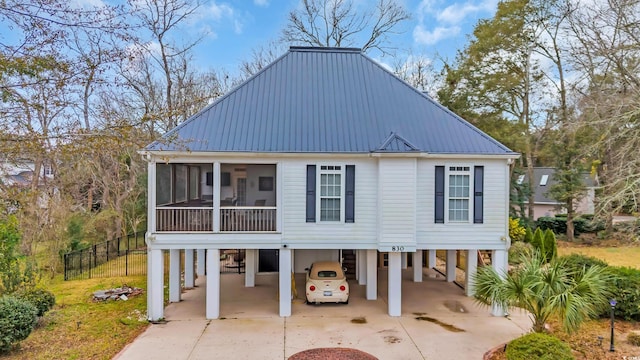 view of front of property featuring a carport and a sunroom