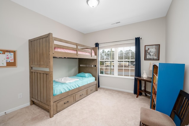 bedroom featuring light colored carpet