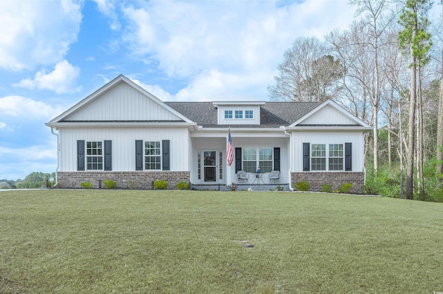 craftsman-style home with a front yard and covered porch