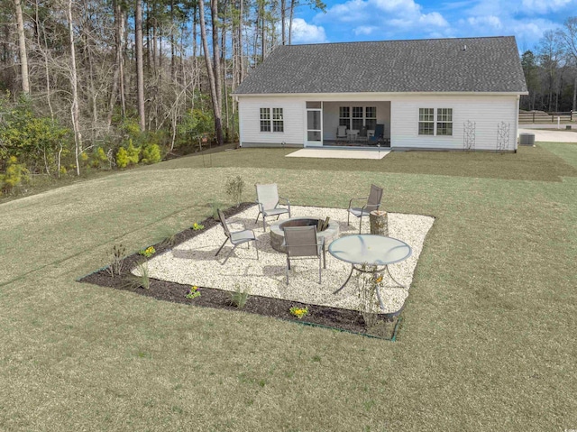 rear view of house featuring an outdoor fire pit, a yard, central AC unit, and a patio area