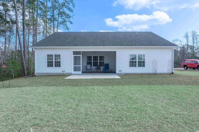 rear view of property with a patio and a yard