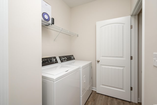 laundry room with dark hardwood / wood-style flooring and washer and dryer