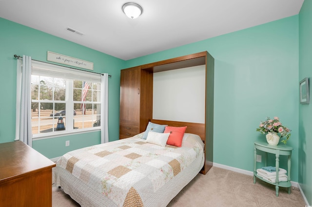 bedroom featuring light carpet