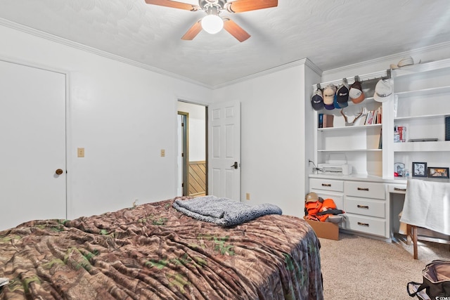 bedroom with light carpet, ceiling fan, ornamental molding, and built in study area