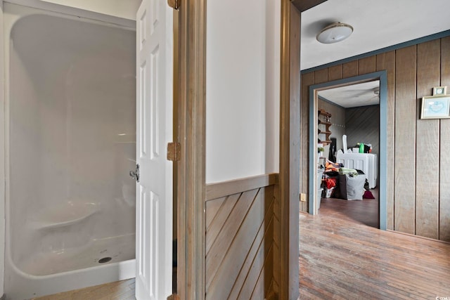 hallway featuring wood walls and wood finished floors