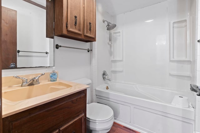 bathroom with washtub / shower combination, vanity, and toilet