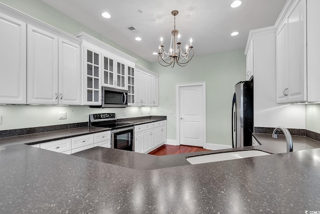 249 Venice Way Unit 3301, Myrtle Beach, SC 29577 - kitchen with hanging light fixtures, stainless steel appliances, white cabinets, dark hardwood / wood-style flooring, and an inviting chandelier
