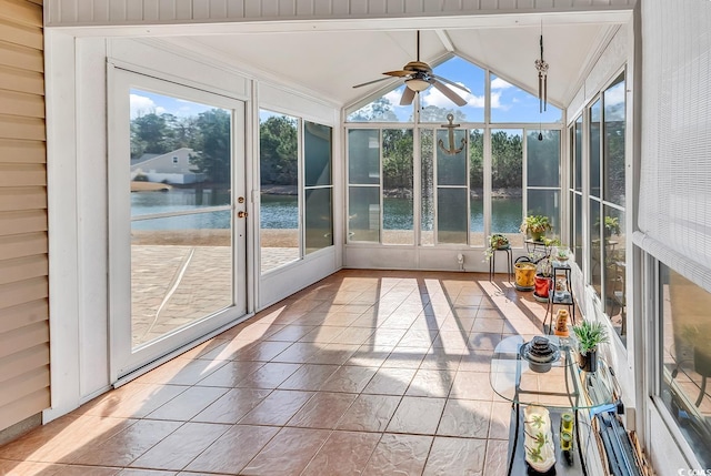 unfurnished sunroom featuring a water view, plenty of natural light, and vaulted ceiling with beams