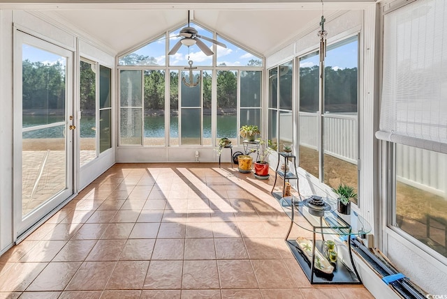 unfurnished sunroom featuring a water view, ceiling fan, and lofted ceiling