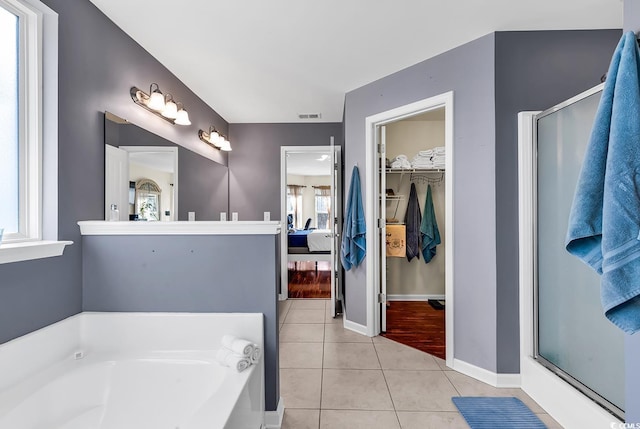 bathroom with tile patterned flooring, plus walk in shower, and vanity